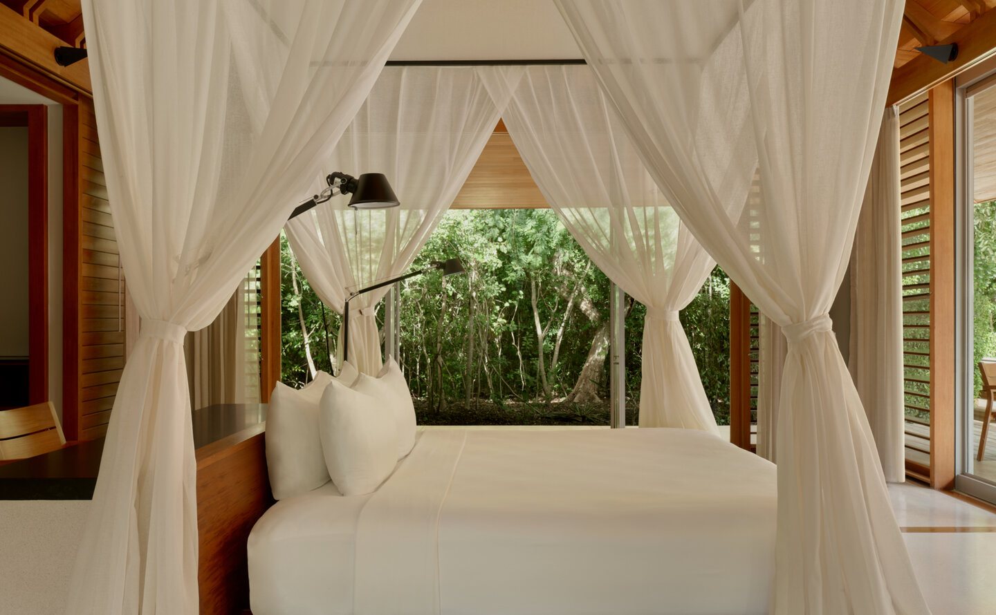 Ocean Pavilion bedroom with draped four-poster bed
