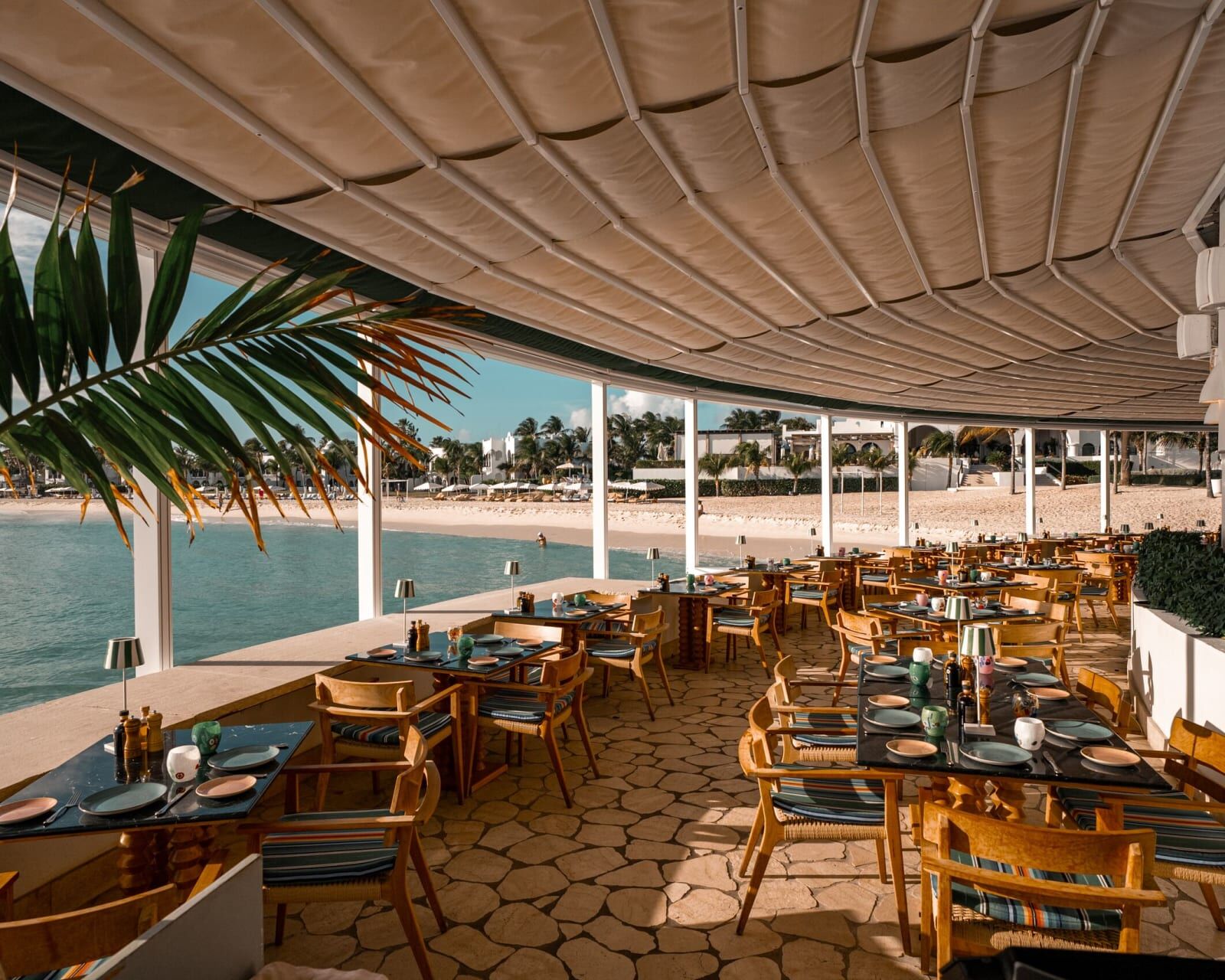 Covered dining terrace beside the beach