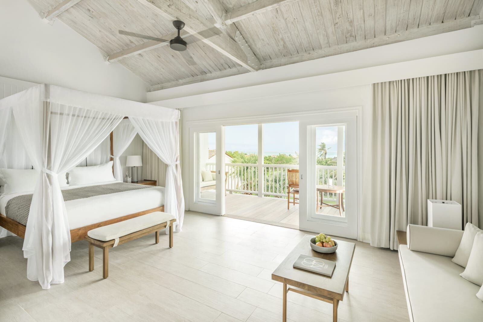 Canopy bedroom opening to a balcony with a sea view