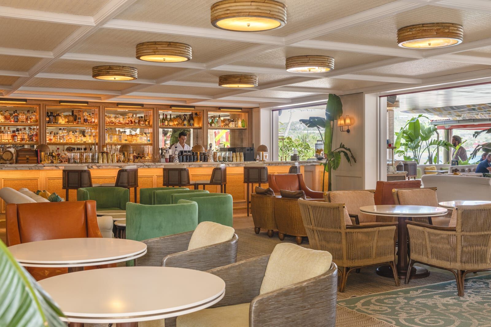 Bar and lounge with green and tan armchairs