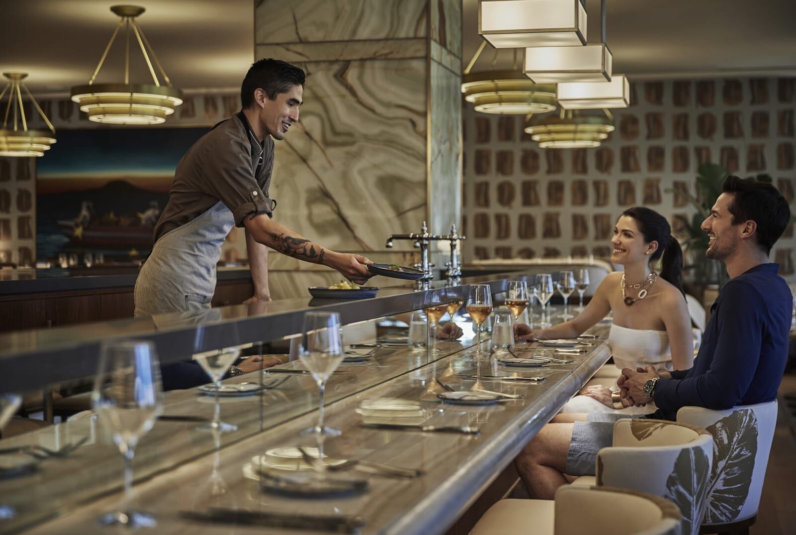 Diners at a bar counter in the evening