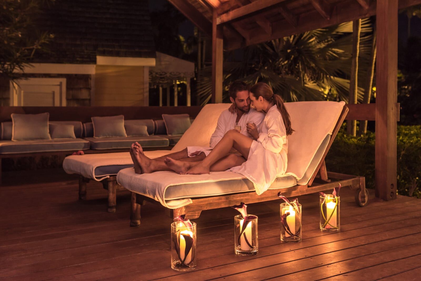 Couple on loungers by lantern light