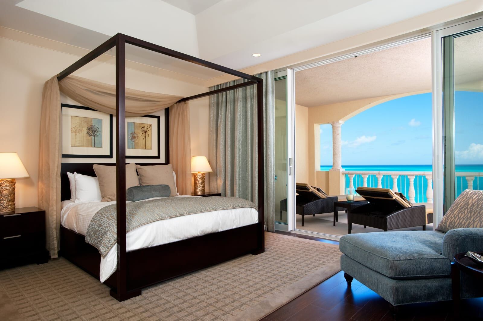 Four-poster bedroom opening to an ocean terrace