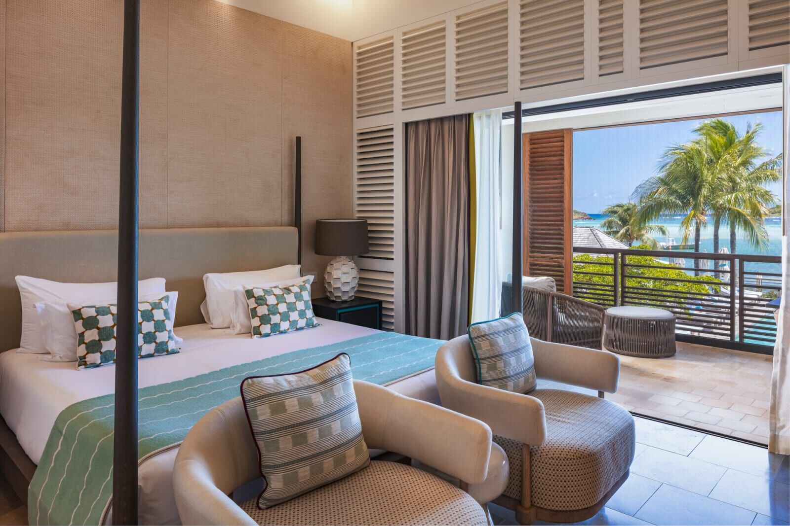 Bedroom with armchairs and an open terrace
