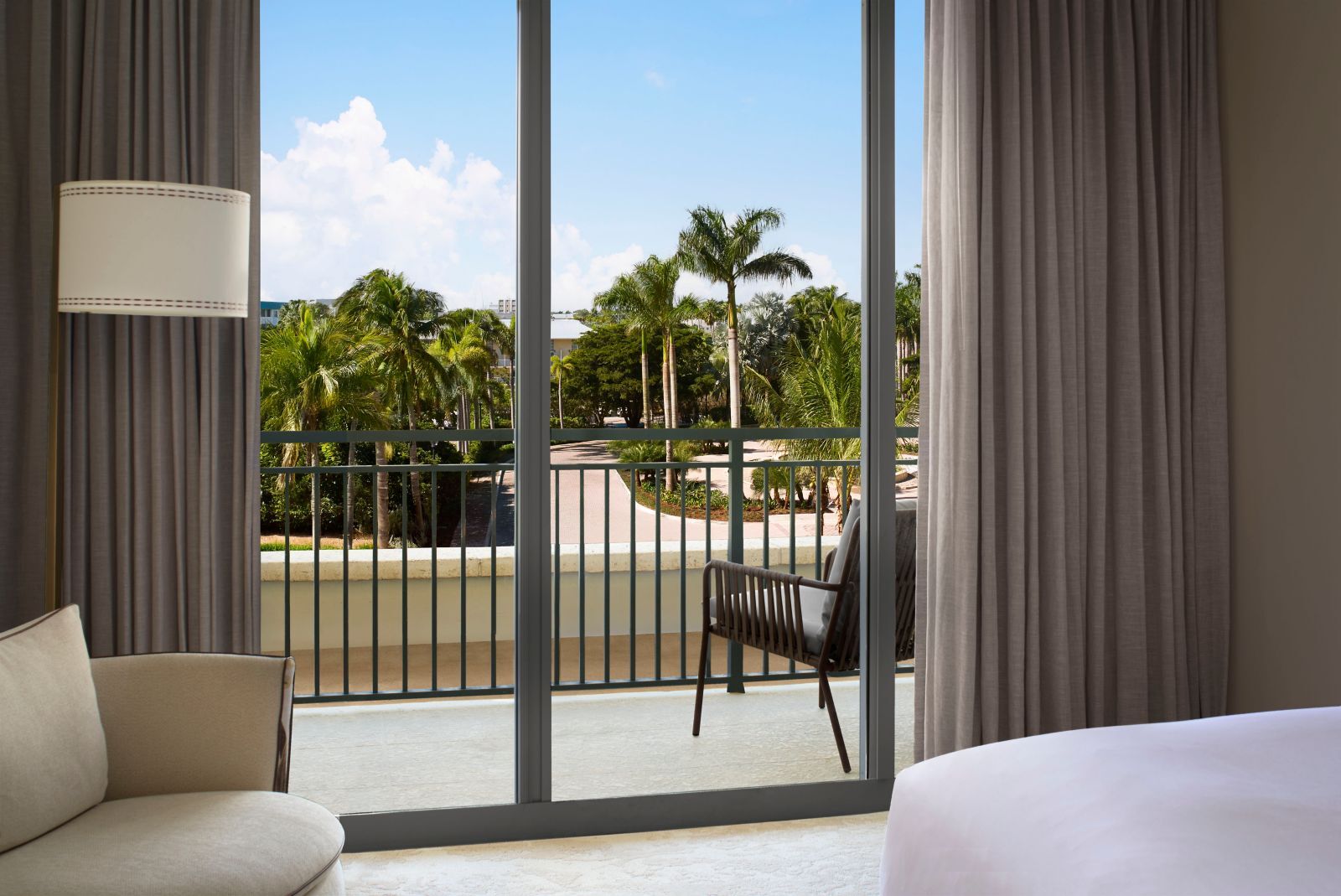 Balcony view of palms and ocean