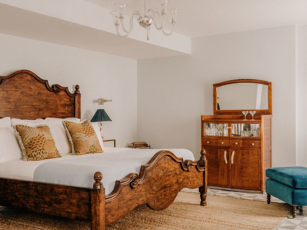 Big bedroom with carved wooden bed