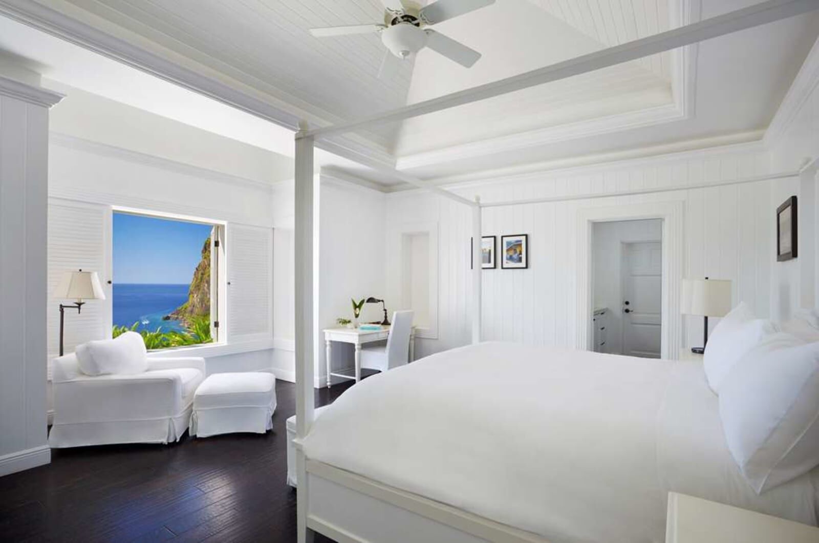 White bedroom with a sea-view window